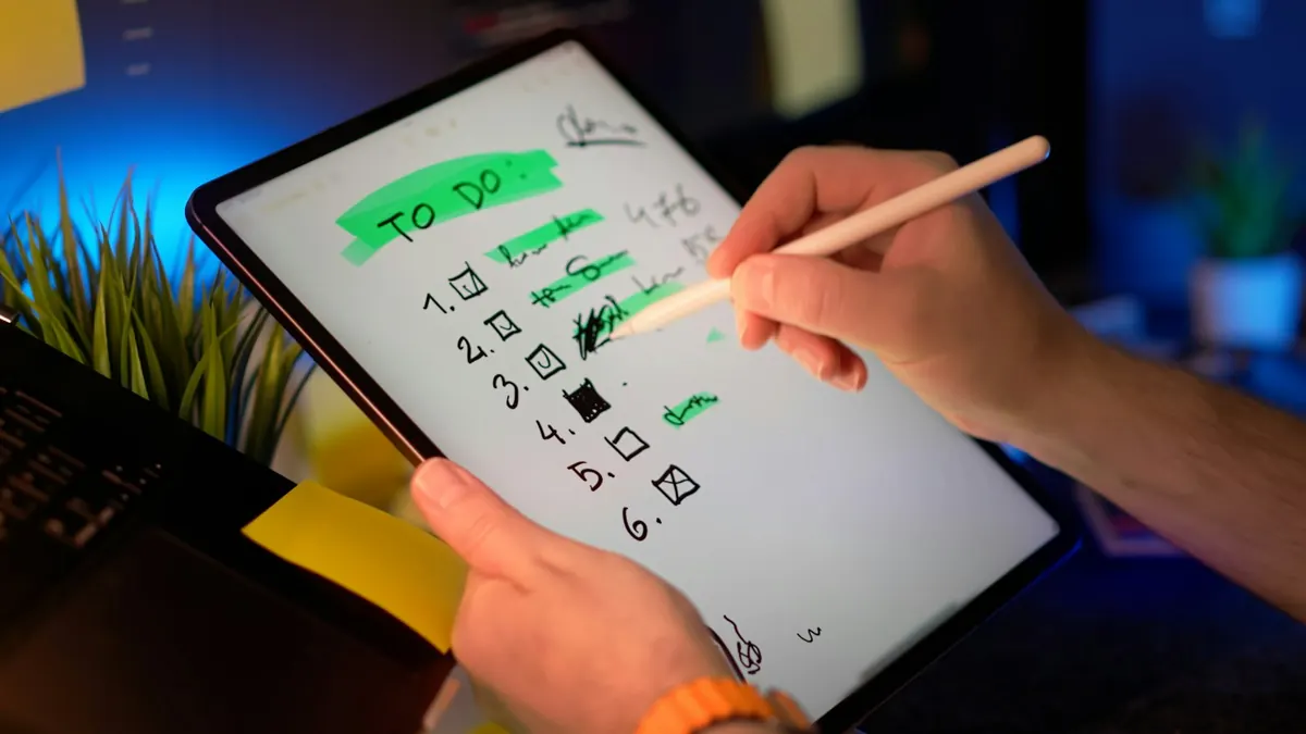 Person checking off a to-do list on a tablet with a stylus