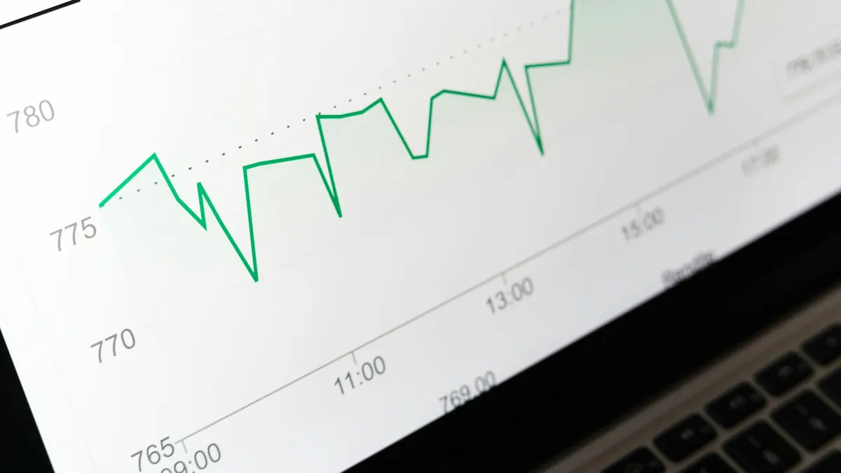 Green line chart on a laptop screen