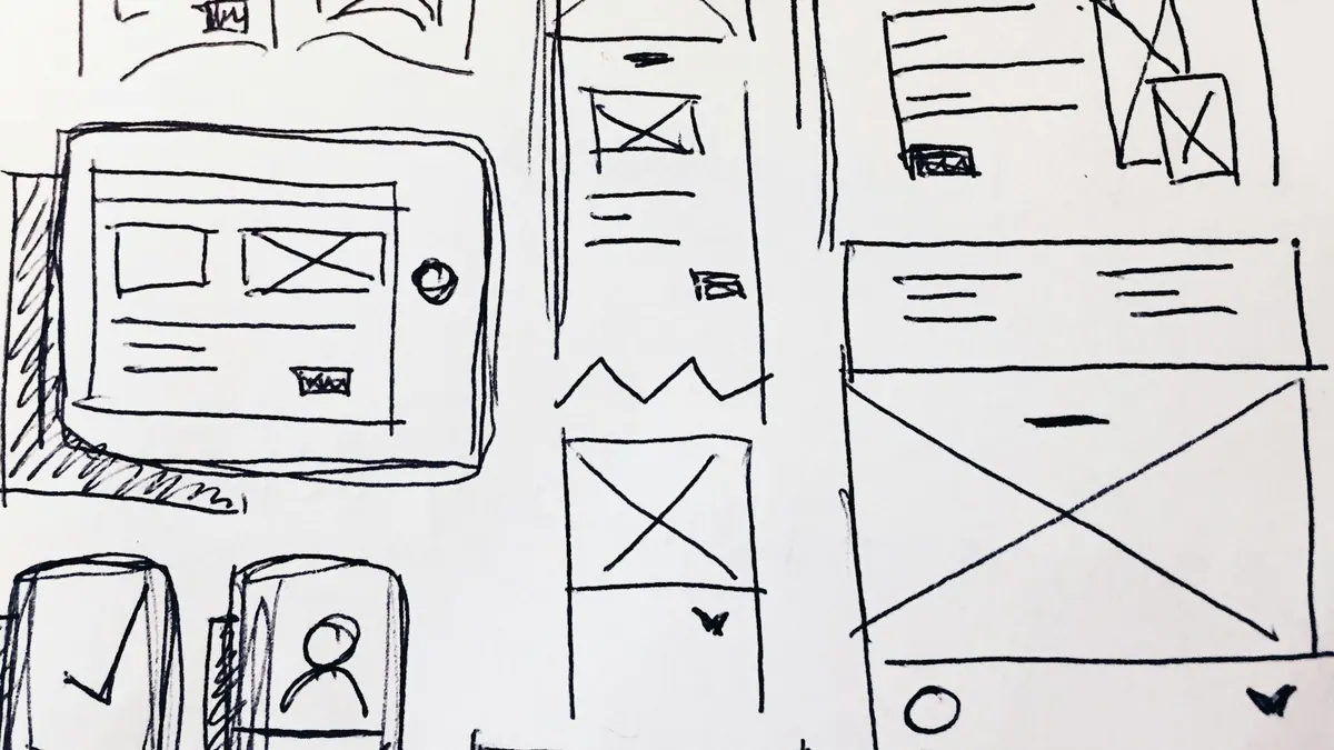 Hand-drawn website wireframe sketches on paper